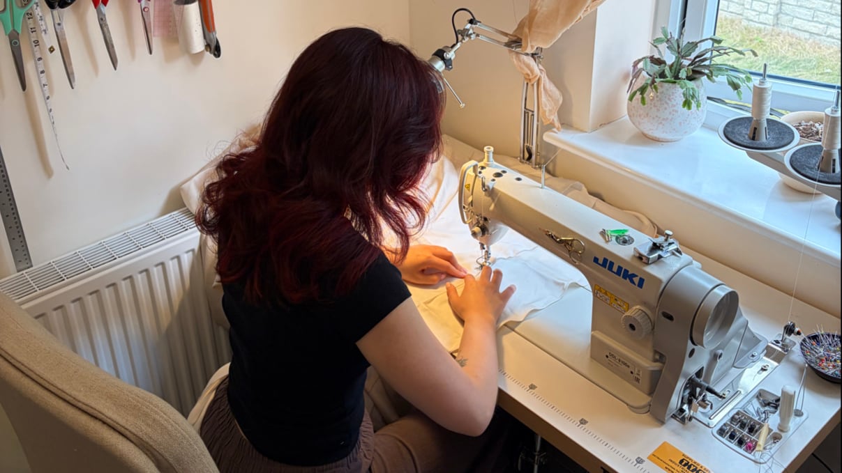 Ruby at the sewing machine in the Oh Sew Perfect studio